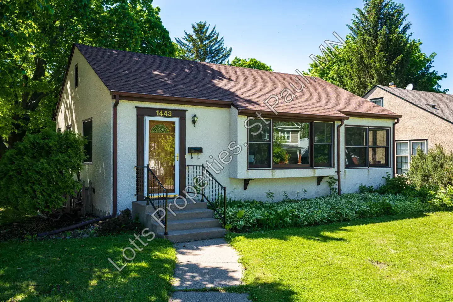 Angled view of the front facade and yard at 1443 Saint Albans