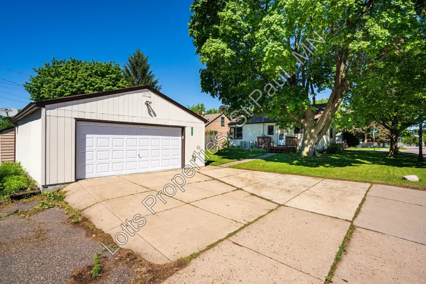 Detached two-car garage and driveway with space for three vehicles at 1443 Saint Albans