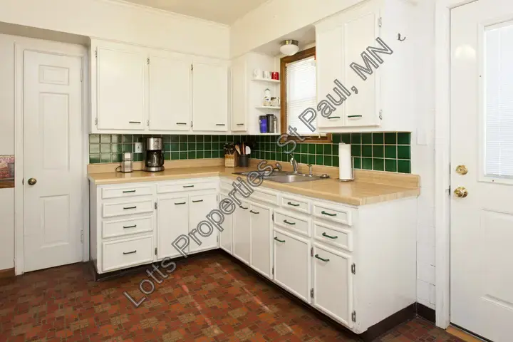 Pre-remodel kitchen corner with pantry door and backsplash