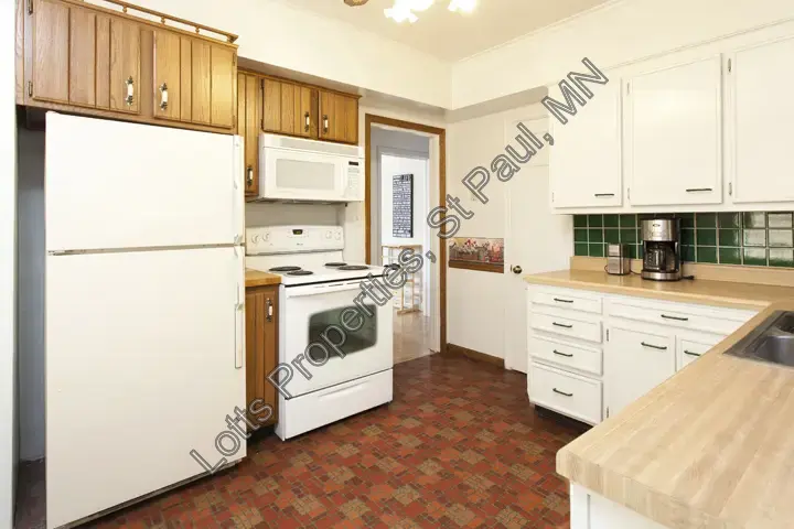 Pre-remodel kitchen appliance wall with cabinetry and prep space