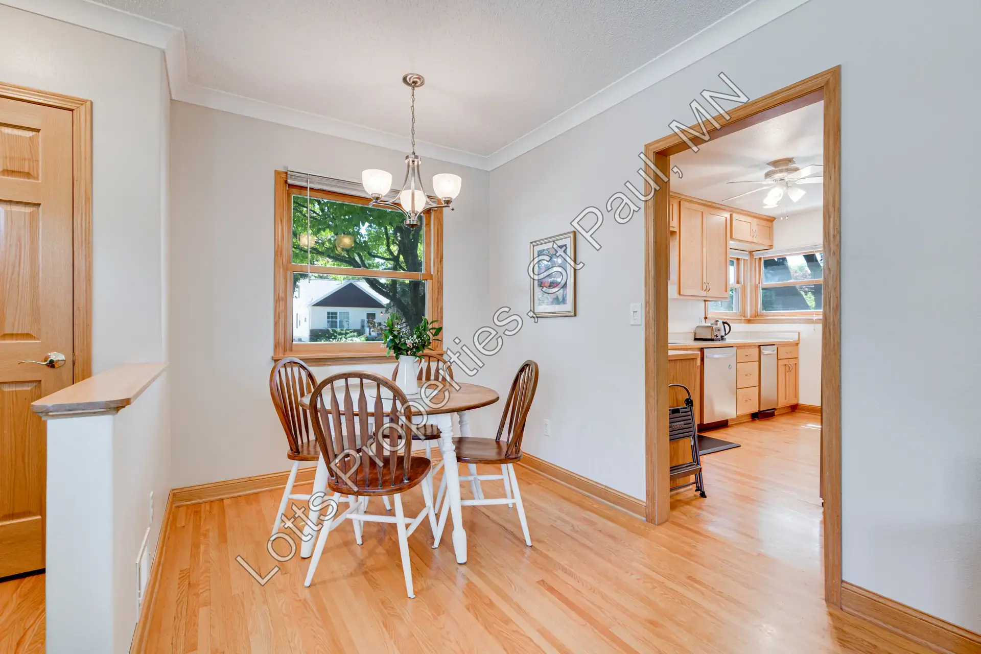 Dining room with hardwood floors and open flow into the living room
