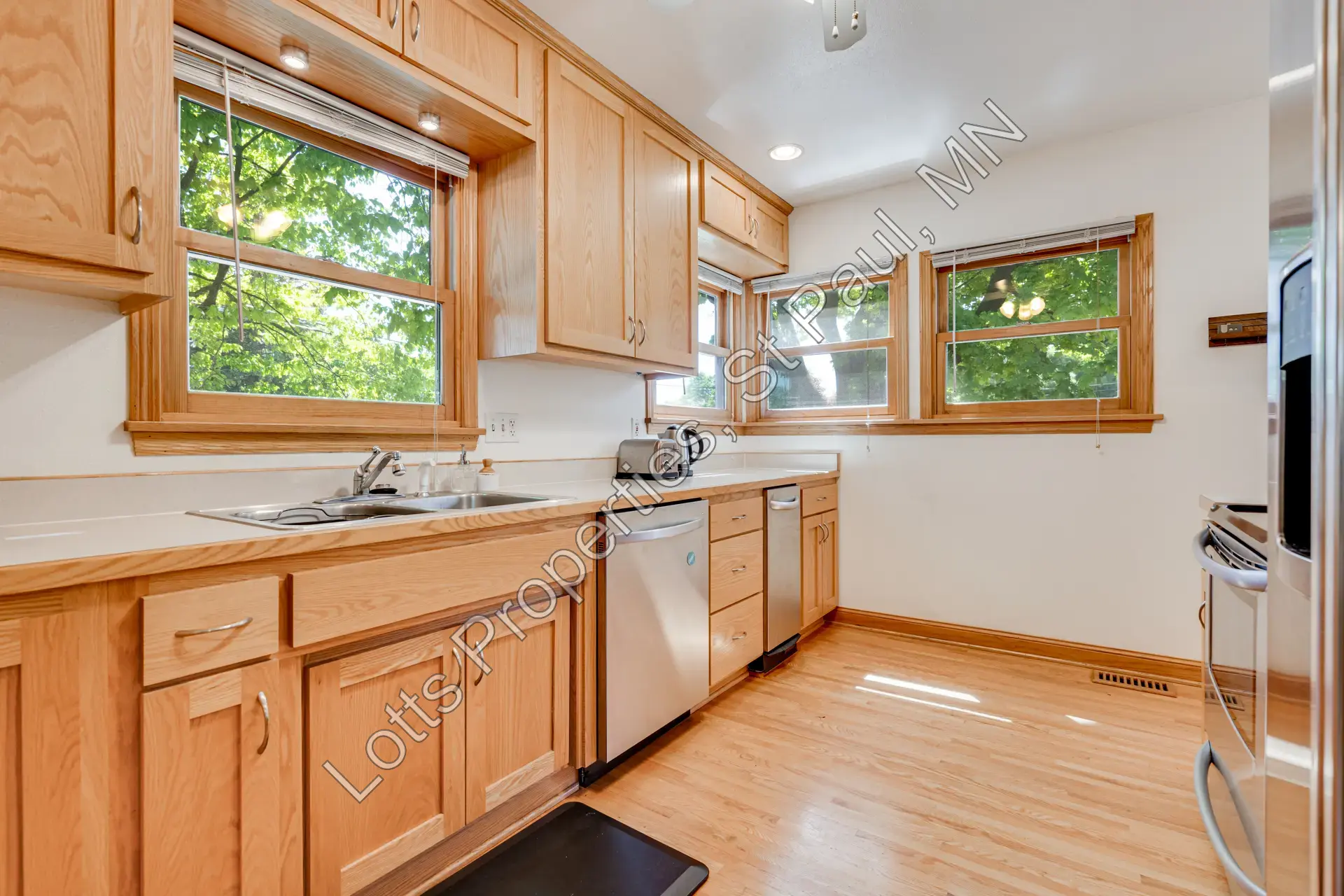 Kitchen sink wall with window and wood cabinetry