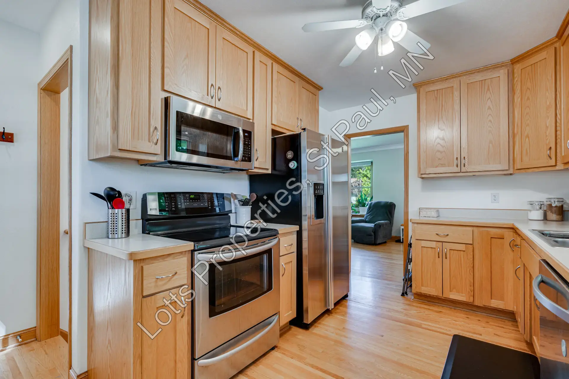 Kitchen with stainless range, microwave, and surrounding cabinetry