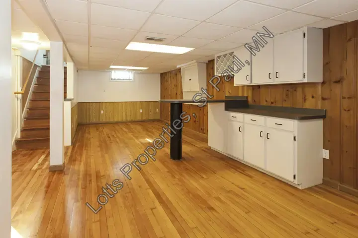 Basement living room and bar area with built-in cabinetry