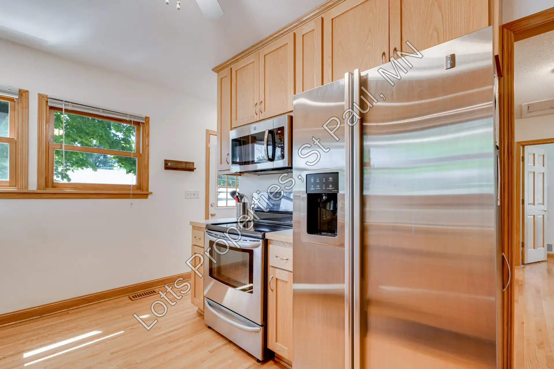 Kitchen appliance wall with refrigerator, stove, and over-the-stove microwave