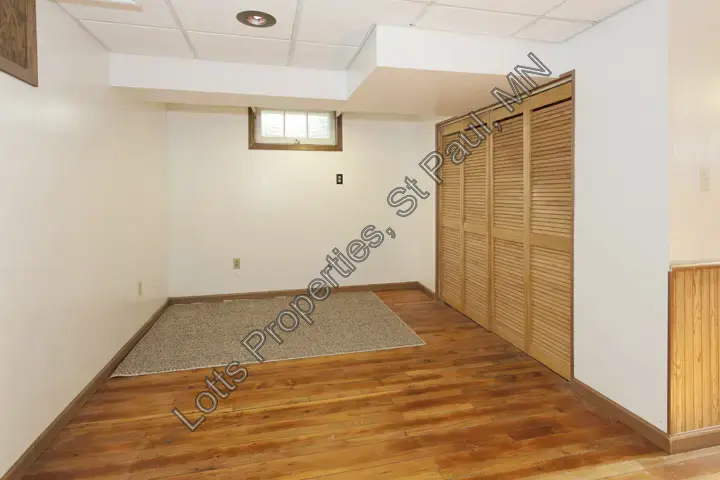 Finished lower-level room with closet and open floor area