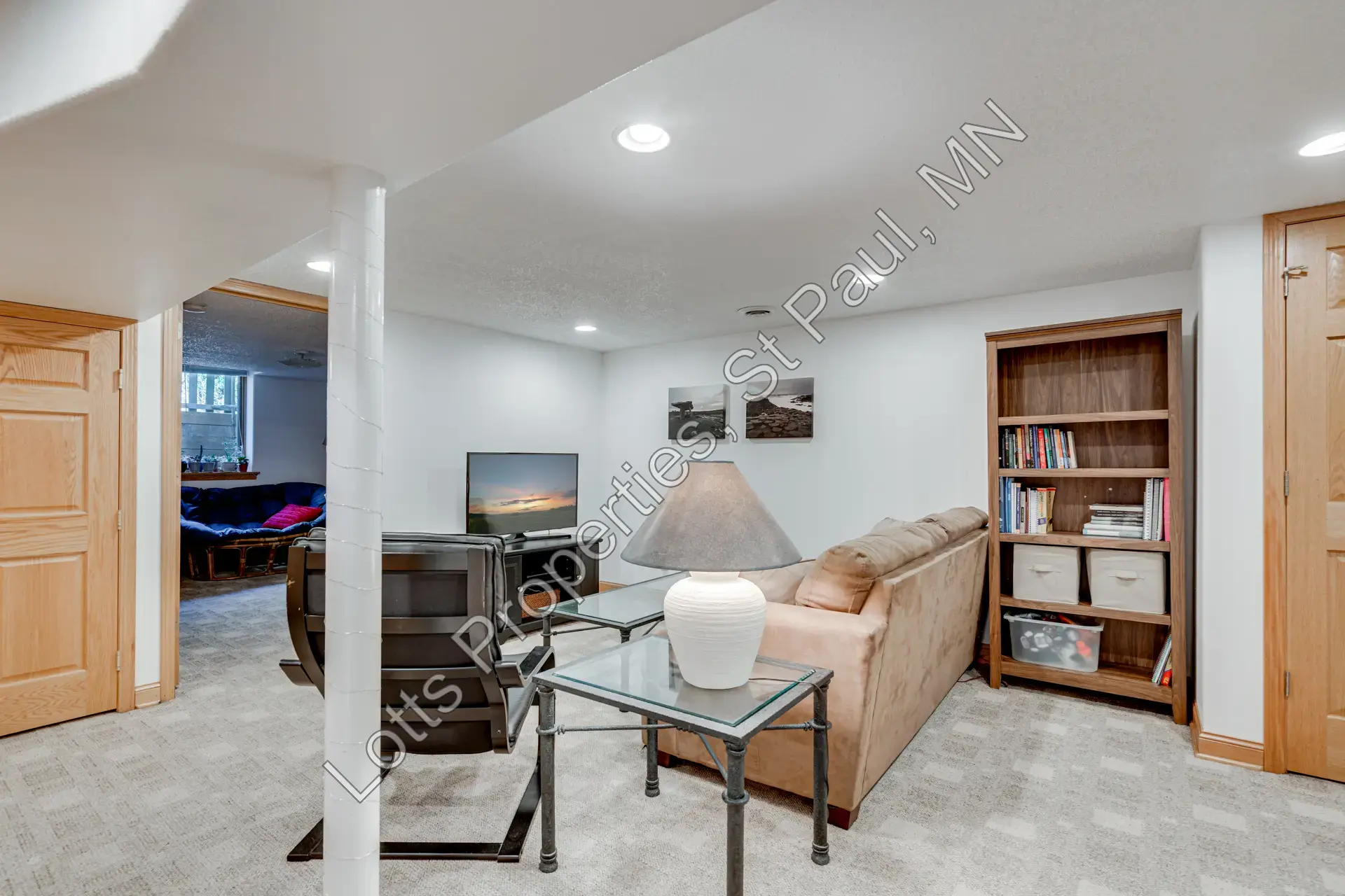 Basement family room with built-in shelving and flexible seating area