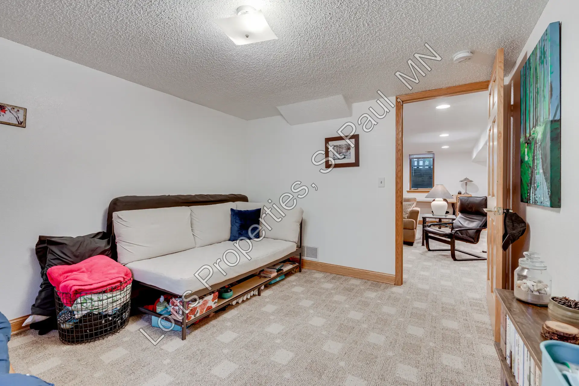 Reverse view of the lower-level east bedroom with daybed and egress window