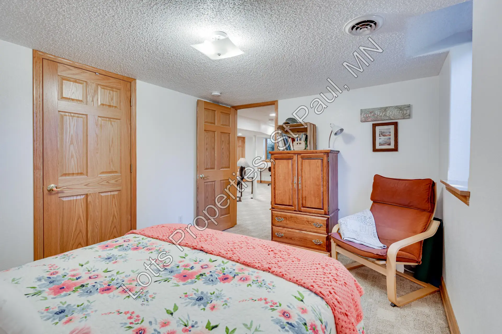 Reverse view of the lower-level west bedroom with dresser and closet